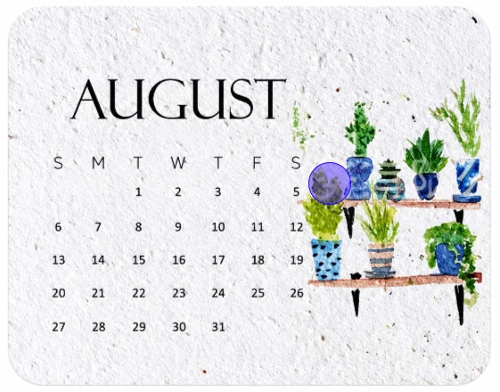 Close-up of a textured seed-paper calendar card with botanical watercolor-style artwork